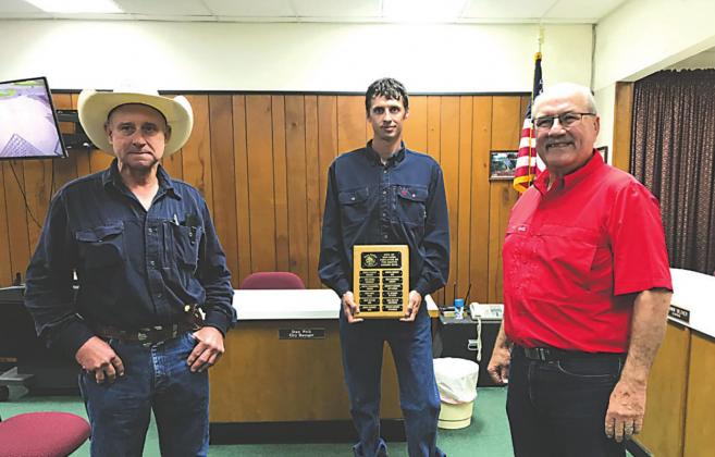 Kyle Anderson, Electric Department employee, displays an Employee of the Month plaque with his name engraved for selection as the City's Employee of the Month for May. He also received a gift certificate to a local restaurant. At Kyle's right is Denver Daniel, Supervisor - Electric Department, and on his left is Stan Weik, City Manager, taking part in the formal presentation. City Staff Photo
