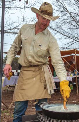Shown at left is Lee Murray cooking up something good, as always. . . and always “Cowboy Style.”