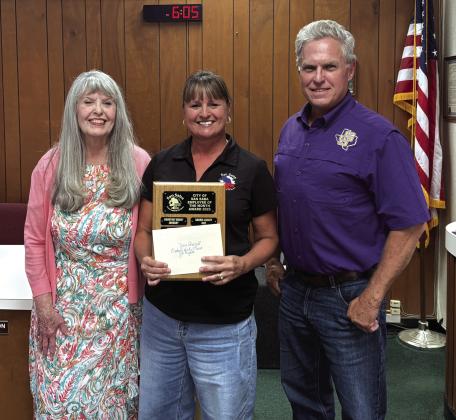 Zane Churchill (center), Accounts Payable Clerk for the City, was chosen as the Employee of the Month for August of 2026. Taking part in the presentation were City Treasurer Charlene Lindsay (left) and Alderman Marcus Amthor (right).