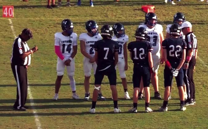 Richland Springs JV Coyotes #14 Ian McKinnerney, #2 Christian McKinnerney, #10 Matthew Woerndell, #33 Hunter Stewart, and #99 Dalton Moats are seen here listening to the referee in the win over Leander Founders Academy last Thursday in Leander.