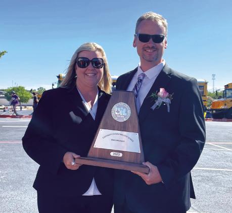 San Saba High School Band Directors Chans and Misty Moellendorf holding their award