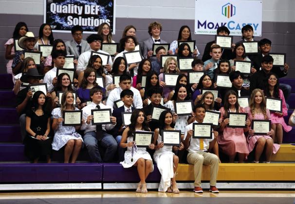 Eighth Graders posing with their diplomas at their graduation to high school. | Photo courtesy of Kayti Lackey/1916Athletics