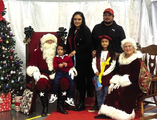 Santa and Mrs. Claus with students, Adriel and Arianna Servin with their parents, Antonio and Maria. All photos courtesy of Dani Gilcrease / SSES Principal