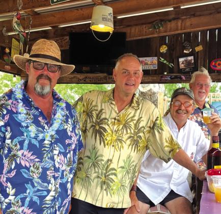 Mark McEwin, Tim Oehlein, Brad Williams, and David Smart were helpful husbands at the Luau.