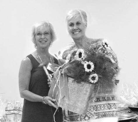 Becky Moore (Right) presents a lovely door prize to winner, Donna Baxter.