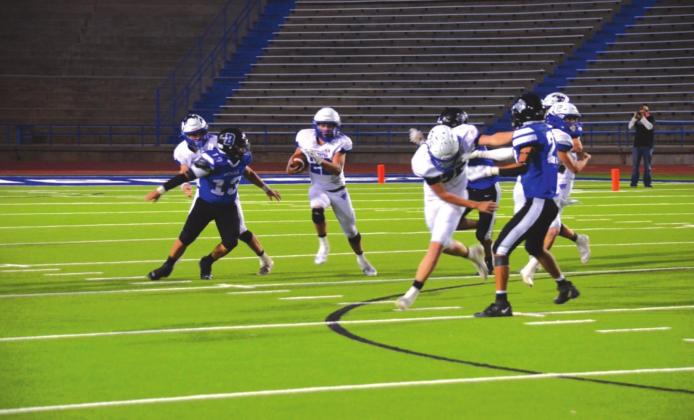 Richland Springs High School varsity football senior quarterback Landon Burkhart (22) scrambles out of the pocket tries to gain extra yardage.