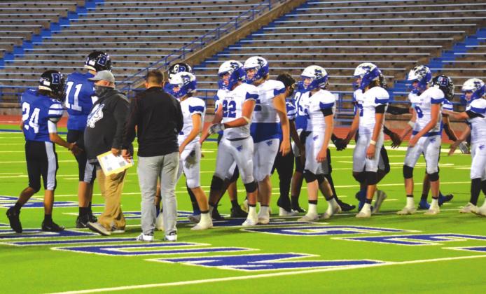 Richland Springs High School varsity football head coach Jerry Burkhart and his players congratulate Balmorhea High School in the handshake line.