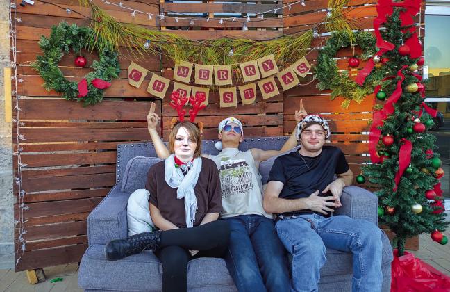 This photo booth courtesy of The Daily Mix was available for the Sip N’ Stroll event last Saturday. Pictured left to right are Kyla Hibler, Casey Hibler, and Emry Roan. Photo by Djuana Payton