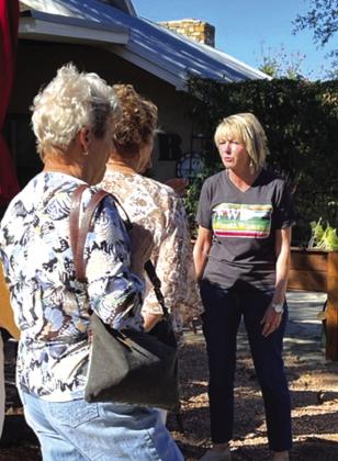 Pictured left: Pedro Jass explains the process of fermenting freshly picked grapes to Pierian members when they visited Fiesta Winery. Pictured right: Fiesta Winery owner, Sally Baxter, gave Pierian members a tour of the grounds at the winery. She has taken a personal interest in the landscaping around the facility which includes multiple seating areas as well as a bandstand/ stage area and a grain bin gazebo.