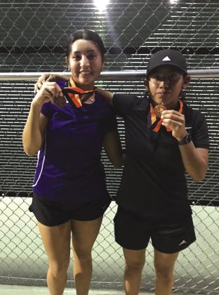 Damares Patino and Minerva Vasquez congratulation winners in Varsity Girls Doubles