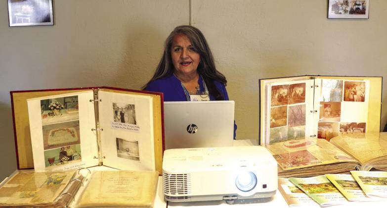 Presenter Dianna Furlan is pictured with a selection of the club’s scrapbooks and historical records spanning almost 90 years. Courtesy of Karen Sloan