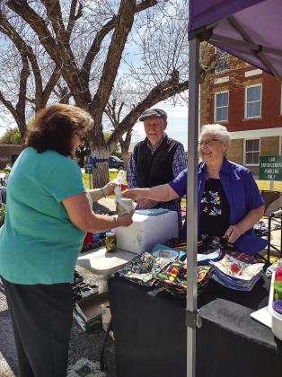 Lori Wiley used to live in San Saba a long time ago and now lives in Brownwood. Her dad used to own the Dairy Queen years ago. She just came down to look around and saw the Pecan Capital Trade Days set up in front of the Courthouse. She couldn’t resist the cheery smiles and Refrigerator Pickles at Don and Joan Van Gorp’s booth!