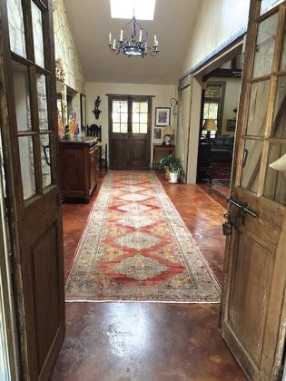 Betsy and Steve Scheffe’s version of an early Texas “dog trot” that adjoins their 1942 farmhouse on the left to their 1850’s barn house on the right.