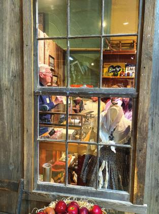 Carl Carter is explaining that the shopkeeper would gather the items on your list from behind the counter instead of you with a cart.