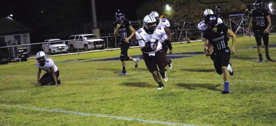 #11 Kenny Triplett (with ball); in the background #32 Cohen Tharp and #10 Jayden Sutherland in Friday night’s game against Lohn. Photo by Pam Starr