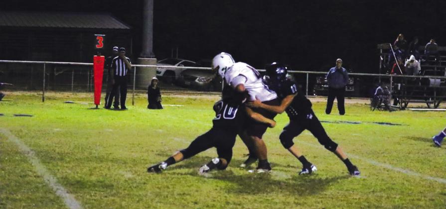 #20 Gage Behrens and #17 Billy Perry making a tackle in Friday night’s game against Lohn. Photo by Pam Starr