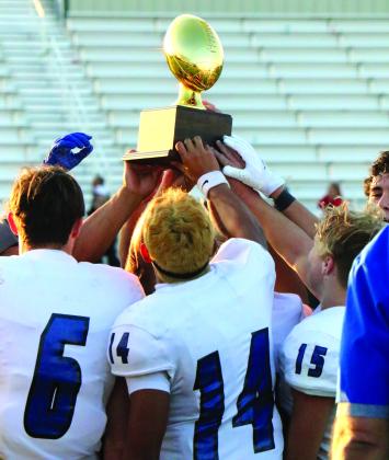 The team holds the trophy high