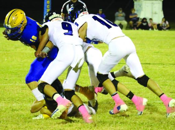 #9 Hutton Rogers and #10 Jayden Sutherland work together to stop a Rochelle Hornet from gaining yards. Photo by Pam Starr