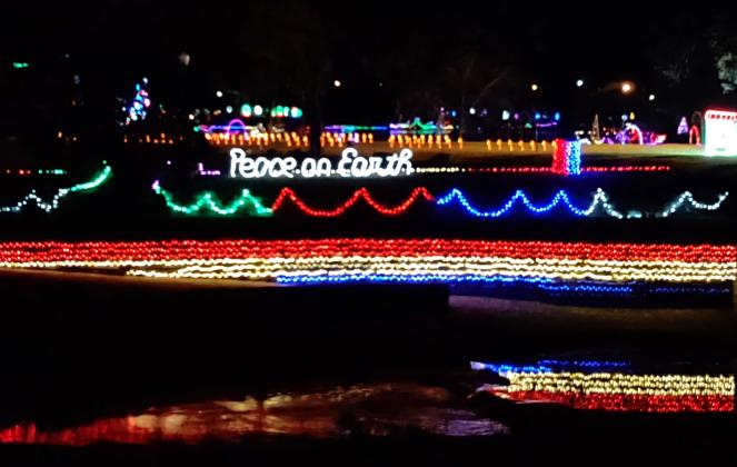 View from East Wallace street shows off the beautiful light display at Mill Pond Park. Colorful lights including their reflection as the water flows from Mill Pond park and makes its way to the Colorado River and the lights surroung Mill Pond are quite a site to see.