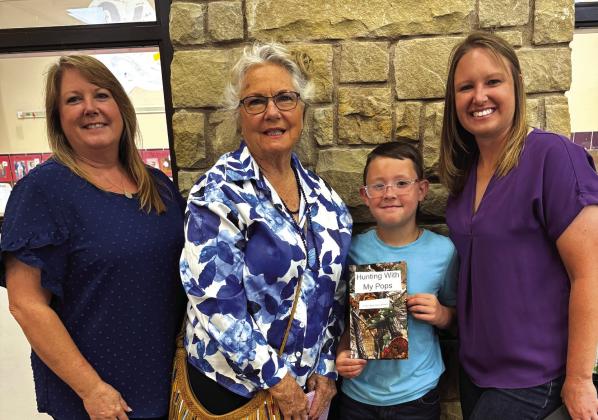Pictured at right: Machelle Roberts Perry (former SSISD Superintendent’s Secretary), Aileen Roberts (former 4th grade teacher), 4th grader Bryce Johnson, and Leanne Perry Johnson (High School Counselor). Bryce and his mom both have books now. Courtesy of Deanne Cromer
