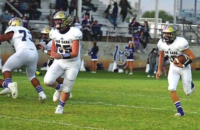 Ty Robertson (#55) leads the way for Wesley Lackey (#10).