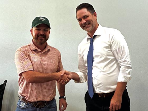 Rotary President Marcus Wood hands over the reigns to incoming president, Jake Lackey.