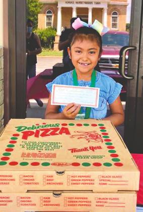 Yadira Macias is shown holding her First Place certificate as the top reader of the Summer Reading Challenge at Rylander Memorial Library!! Awarded were the two large pizzas from Napoli’s placed in front of Yadira.