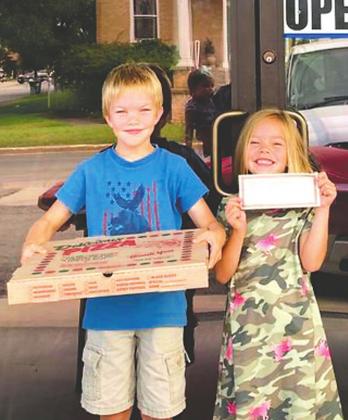 Wyley Murray is shown holding a pizza while his sister holds his earned certificate showing him a Second Place winner in Rylander Library’s Summer Reading Challenge. Napoli’s awarded Wyley a large pizza for his significant accomplishment.
