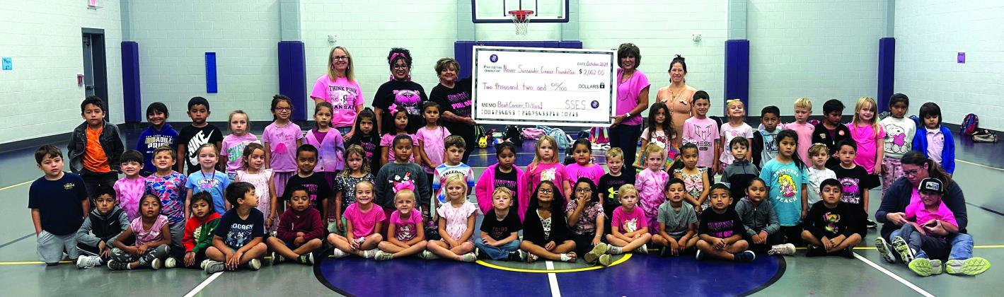 SSES Elementary students with their teachers and the Never Surrender Cancer Foundation representatives. Adults in the back: Mrs. Oliver, Mrs. Ceci, Donna Shahan, Dora Miller, and Mrs. Bessett. Courtesy of Dani Gilcrease