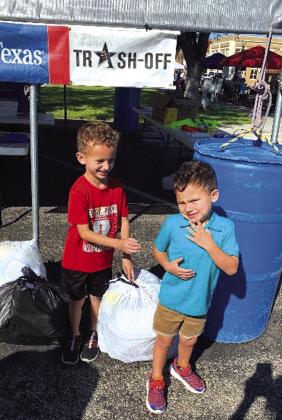 Second place winner, Asher Smith, submitting his bags of plastic beverage bottles. He is accompanied by his brother, Jett Smith.