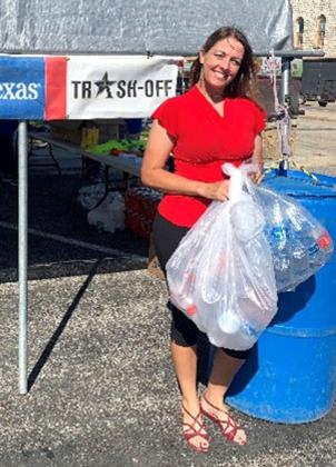 Third place winner, Ginger Sampson, is dropping off her bottles for recycling.