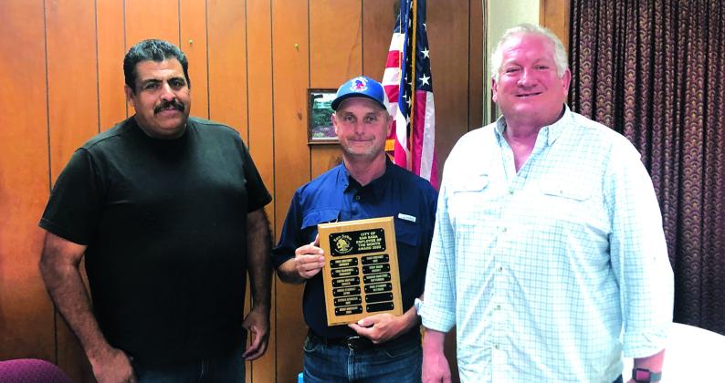 Paul Stewart, Street Department employee, is shown holding the Employee of the Month plaque. Pictured to his right is Street Department Supervisor Luis Rios and to his left is Alderman Shawn Oliver. Photo by Scott Glaze