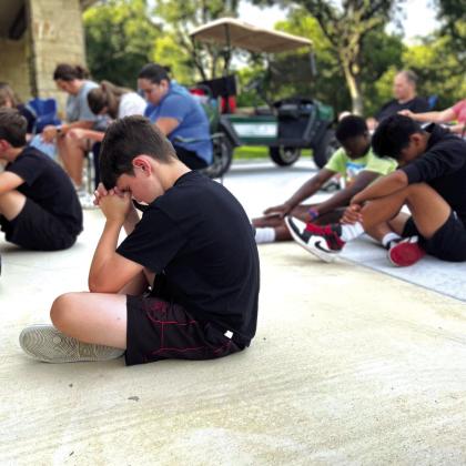 Luke praying at the Wednesday night devotional time