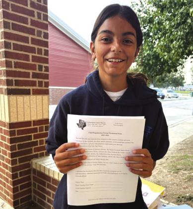 Mia Davila is holding the parent permission form. Courtesy of Dynasty Jackson