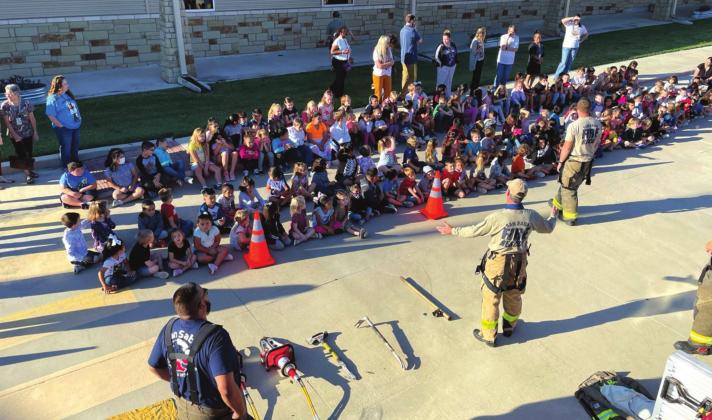 Volunteer firefighters shown in foreground are L-R: Juan Montoya, Jack Blossman, and Michael Ward.