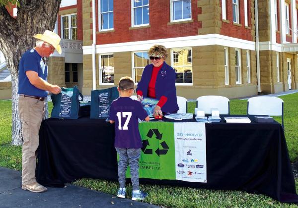 Buddy Whitley and Mateo Martinez at the recycle awareness table. Courtesy of Sarah Saldivar