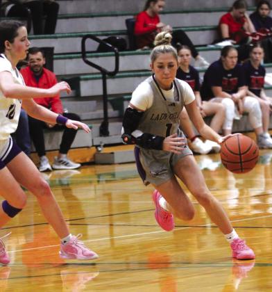 Varsity - #1 Olivia Sebastian driving to the basket against Early
