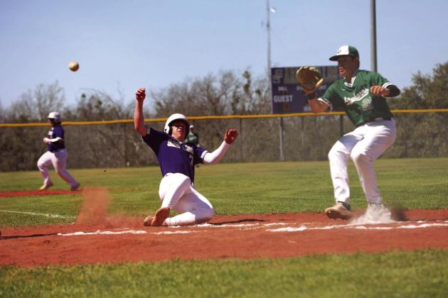 #7 Jason Everett making the safe slide home in Tuesday’s spring break district match up against the Harper Longhorns.