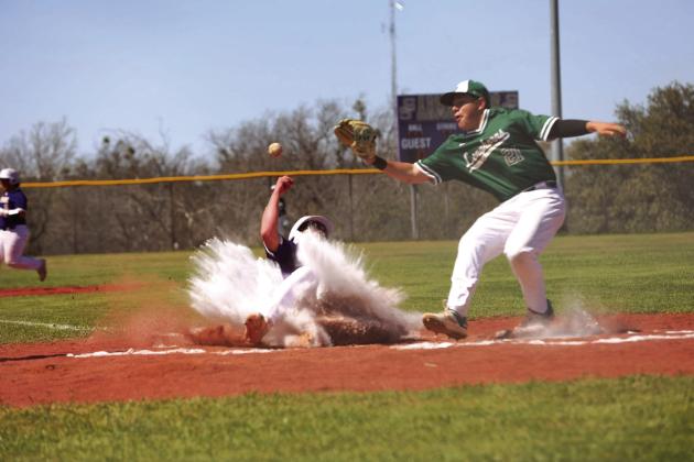 #7 Jason Everett making the safe slide home in Tuesday’s spring break district match up against the Harper Longhorns.