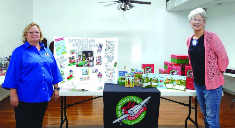 Lisa Valdez (left) gives a presentation on Operation Christmas Child at the Rotary Club Meeting that was held on October 20th at Pepperbelly's. Pictured with Lisa at the right of the display table is Beth Griess, Rotary Club President.