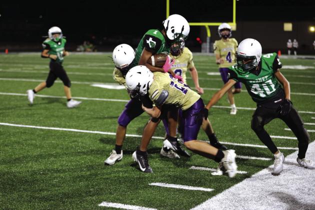 Donte Smith making a defensive stop for the Dillos in their win against Burnet.