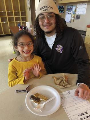 Families read and followed directions to make s’mores together. Then using their five senses, they described how the s’more smelled, tasted, felt, sounded, and looked. Each kindergartner got to choose 5 little readers to take home to read with their family. It was a fun night! Yedid Rodriguez and Leonel Aranda