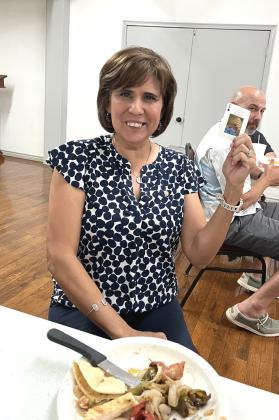 Dora Miller is taking a break from eating her fajita plate to accept the winning 'Ace of Spades' card as the winner of the Rotary weekly drawing at Pepperbelly's Restaurant last Thursday, July 27th.