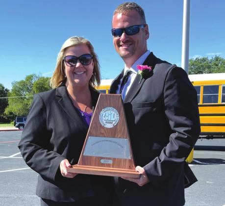 Pictured at right: Golden Armadillo Band directors Chans and Misty Moellendorf show off the trophy.