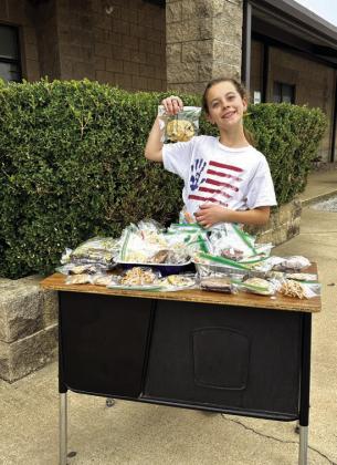 Addie Merriman displaying baked goods for the Wreaths Across America fundraiser. Courtesy of Shannon Padgett