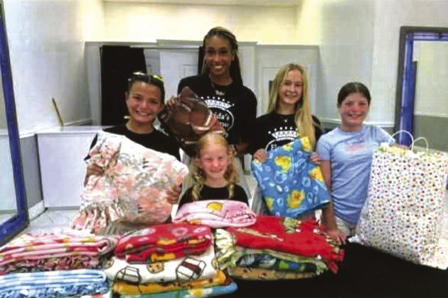 Alexis Blasky and her friends Shakira, Jade, Harper and Kennedy share their love with San Saba with these homemade blankets.