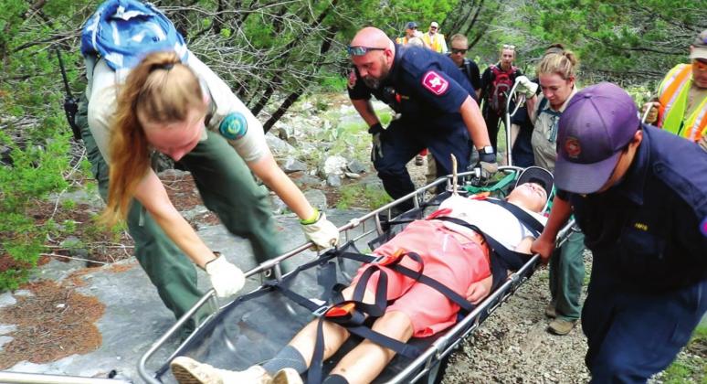 Step 3 - Transport the “victim” to awaiting medical vehicle or helicopter. Using a basket stretcher, First Responders learned the difficulties in transporting an injured patient in wilderness terrain. Success again!