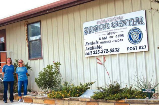 After: An inviting xeriscape flowerbed. Gayla Paredez, Director of the Senior Center (left) and Mona McMahan, Co-President of the San Saba Garden Club (right)
