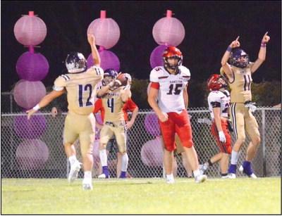 Winton Lackey (12), Levi Glover (11) celebrate Skylar Romero’s (4) interception.