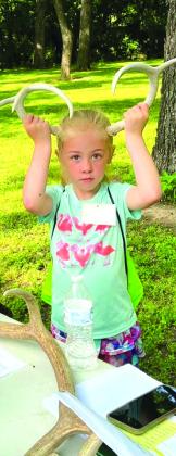 Pictured at right: The Kamp children repurposed clear bottom buckets, then seined their finds to identify what they found in the park’s creek.